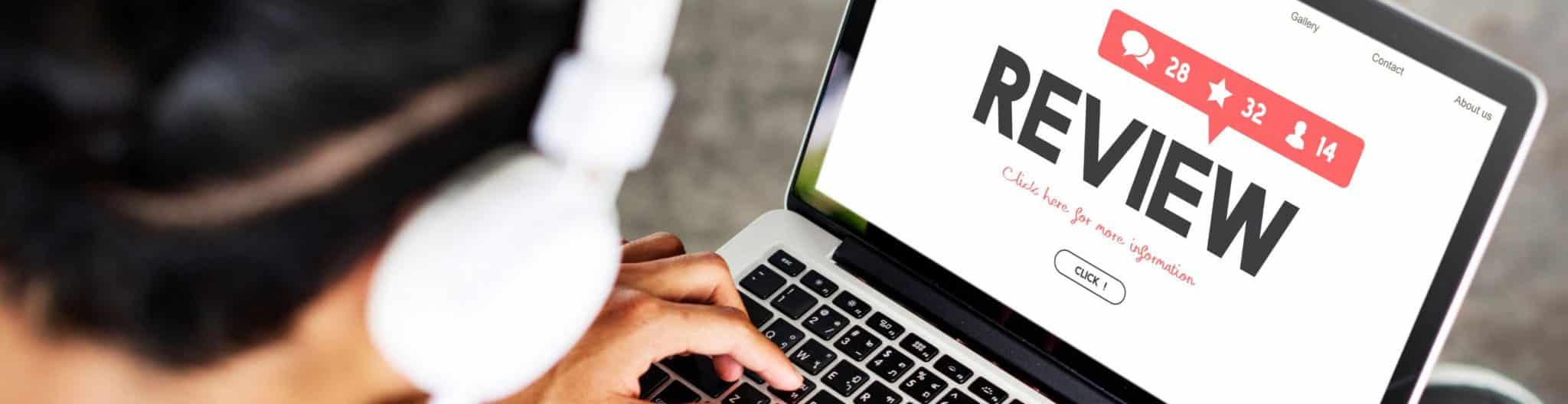 A medical professional on laptop deciding if client reviews are a waste of time.